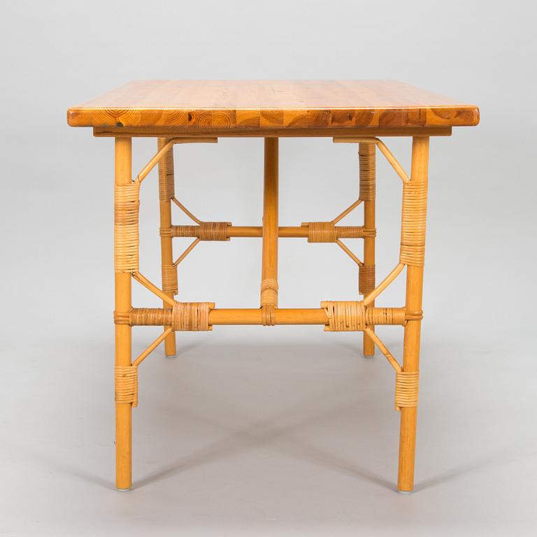 A pine wood and rattan table, late 20th century.