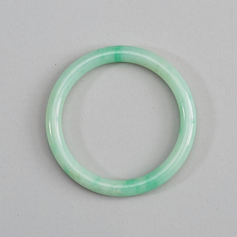 A green jadeite bangle, China, 20th Century.