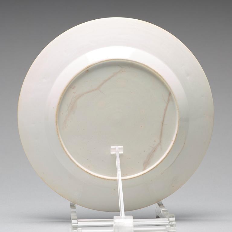 A set of four blue and white armorial dinner plates, Qing dynasty, 18th Century.