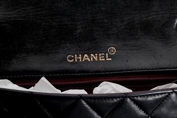 A black quilt leather shoulder bag by Chanel.