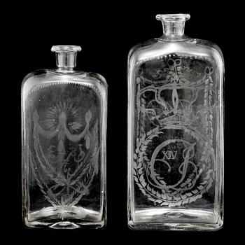 BRÄNNVINSFLASKOR, 2 st, glas, daterade 1833 respektive 1843.