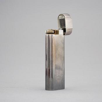 A must de Cartier silver plated cigarette lighter.