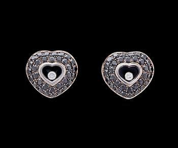 1117. A pair of black and white Chopard 'happy diamond' heart earrings.