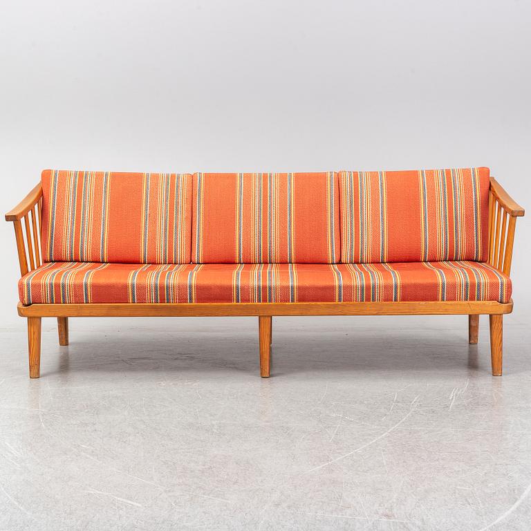 A Swedish 1960s Carl Malmsten pine wood sofa.