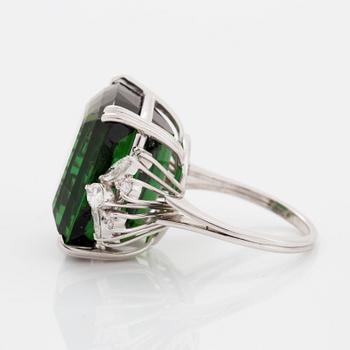 An 18K white gold ring set with a green tourmaline and round- and marquise brilliant-cut diamonds.