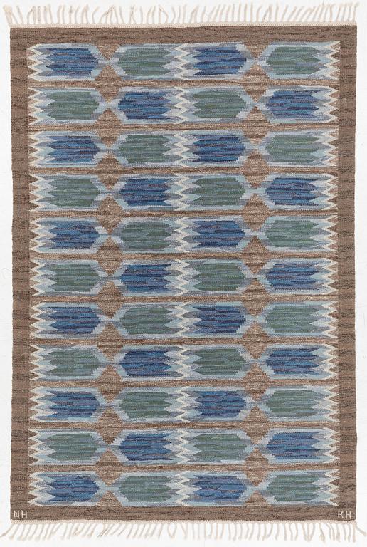 A flat weave carpet from Klockaregårdens Hemslöjd, Sweden, siged KH & NH, ca. 242 x 169 cm.