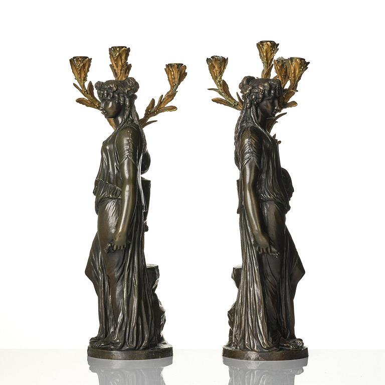 A pair of Louis XVI-style four-light gilt and patinated bronze candelabra after Clodion, later part 18th century.