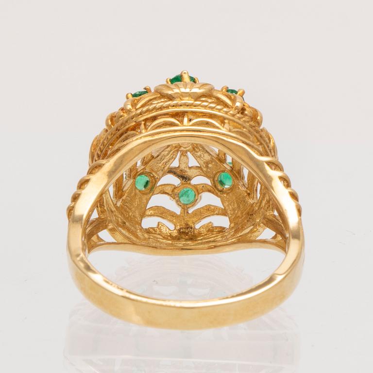 An 18K gold ring set with a round brilliant cut diamond and round single cut emeralds by Franklin Mint 1980.