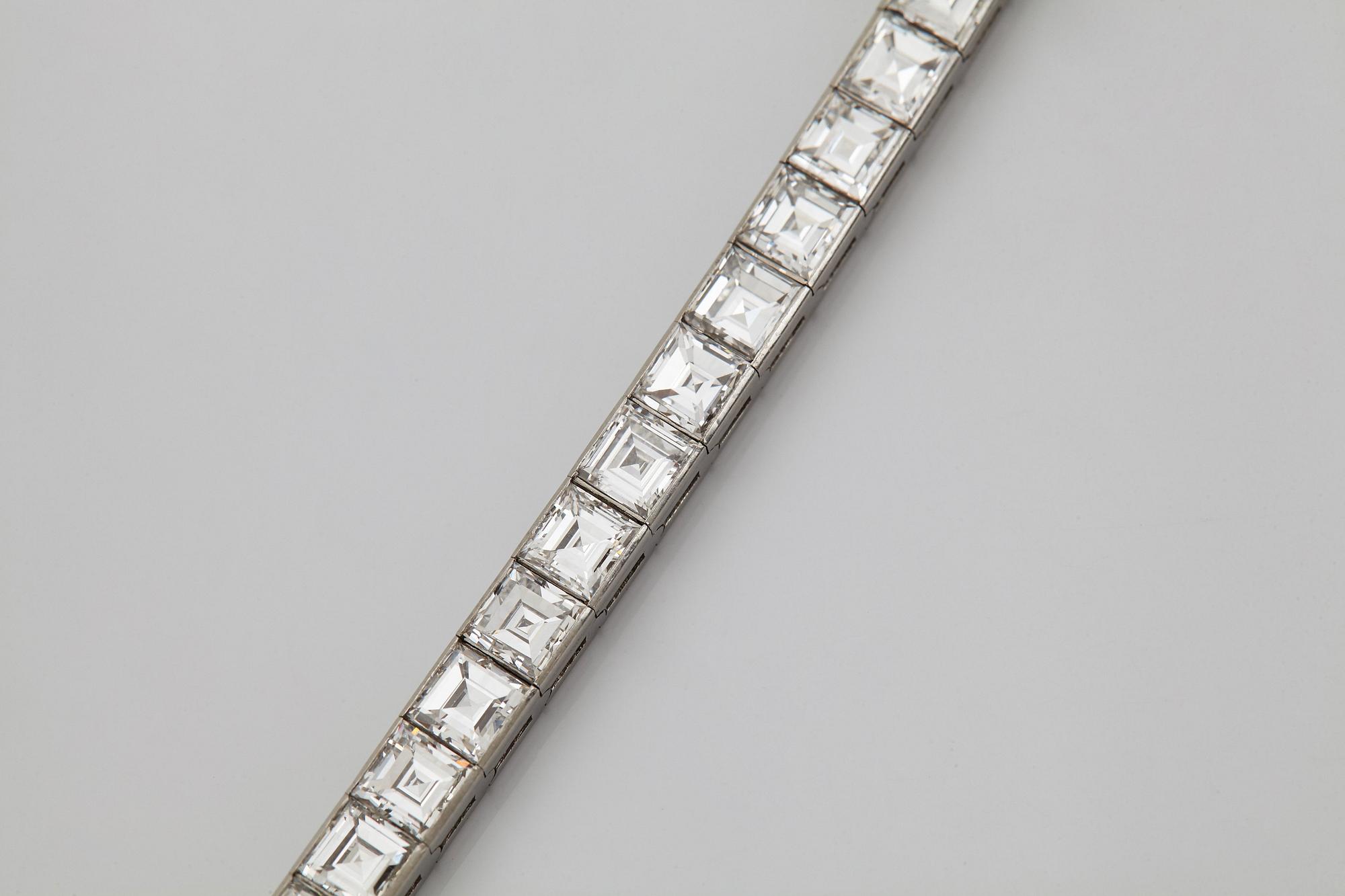A platinum bracelet set with carré cut diamonds.