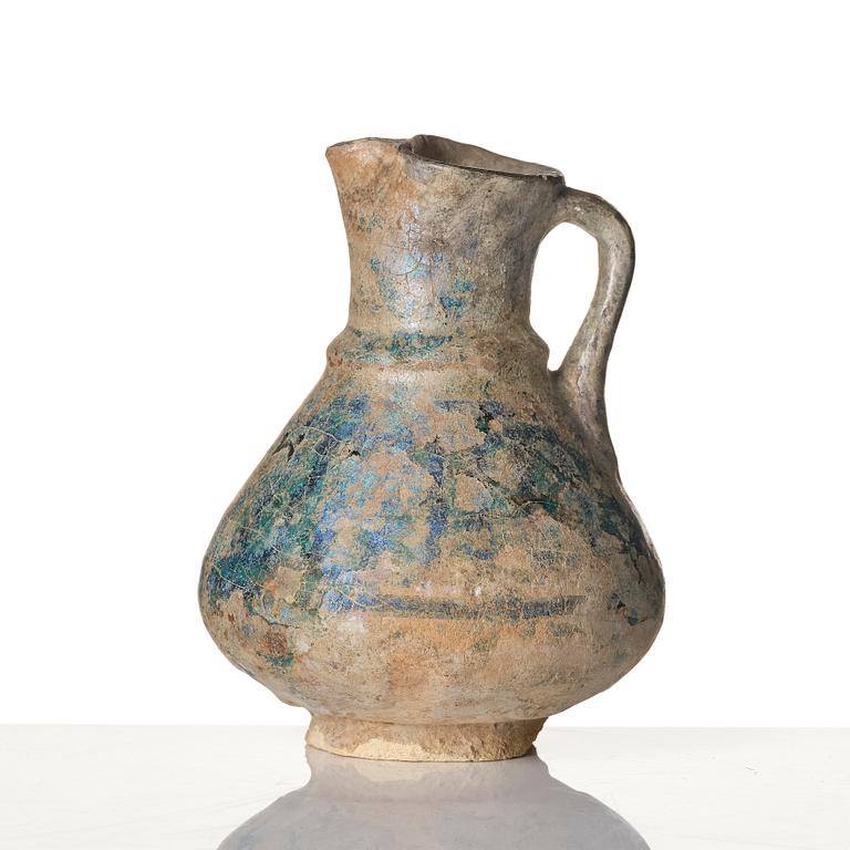 A turquoise-glazed Keshan jug, Persian, 13th century.