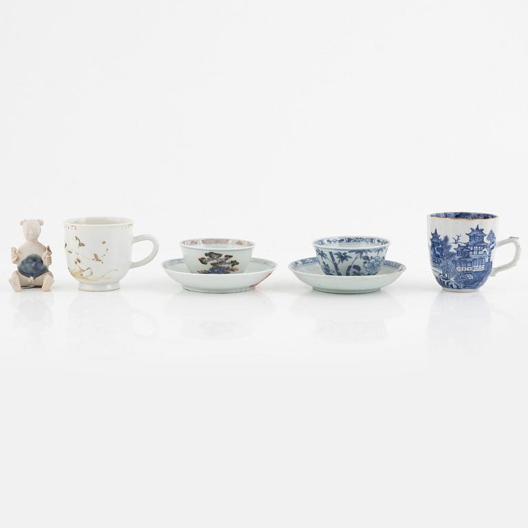 Two Chinese export porcelain cups with saucers, two cups, and a figurine, Qing Dynasty, 18th century.