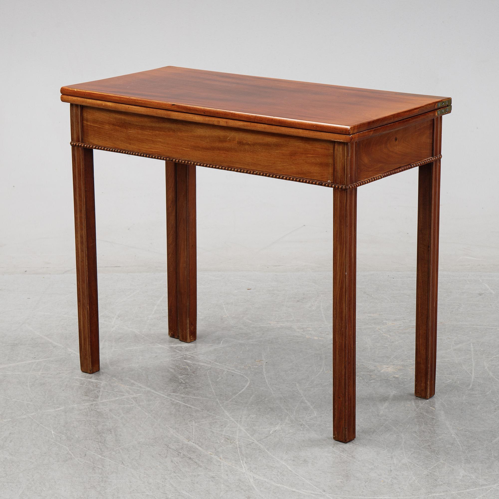 A mahogany games table, circa 1800.