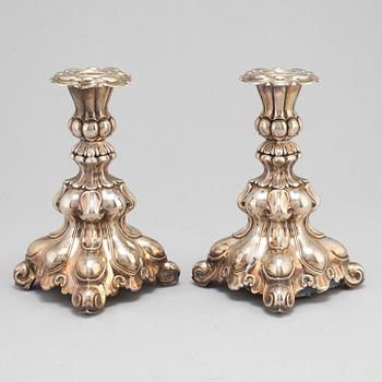A pair of silver candle sticks.-.