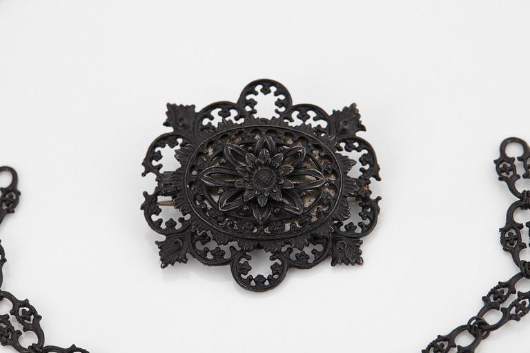 A Berlin steel and iron parure comprising a necklace, two bracelets and a brooch.