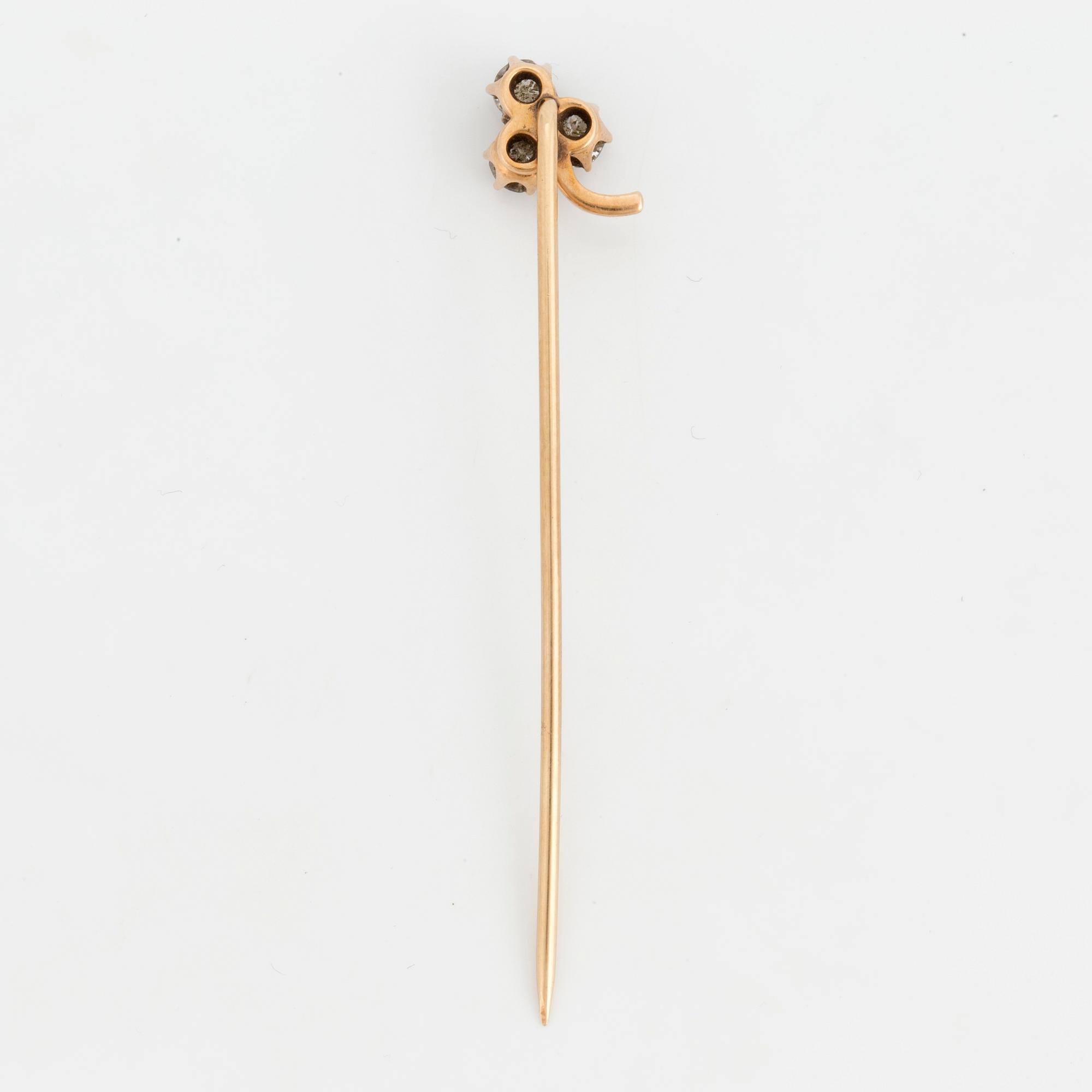 A TIE-PIN, 14K gold with three old cut diamonds.