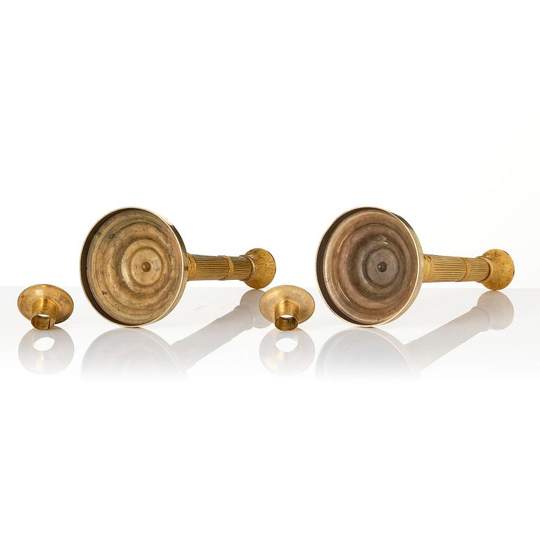 A pair of French Empire ormolu candlesticks, early 19th century.