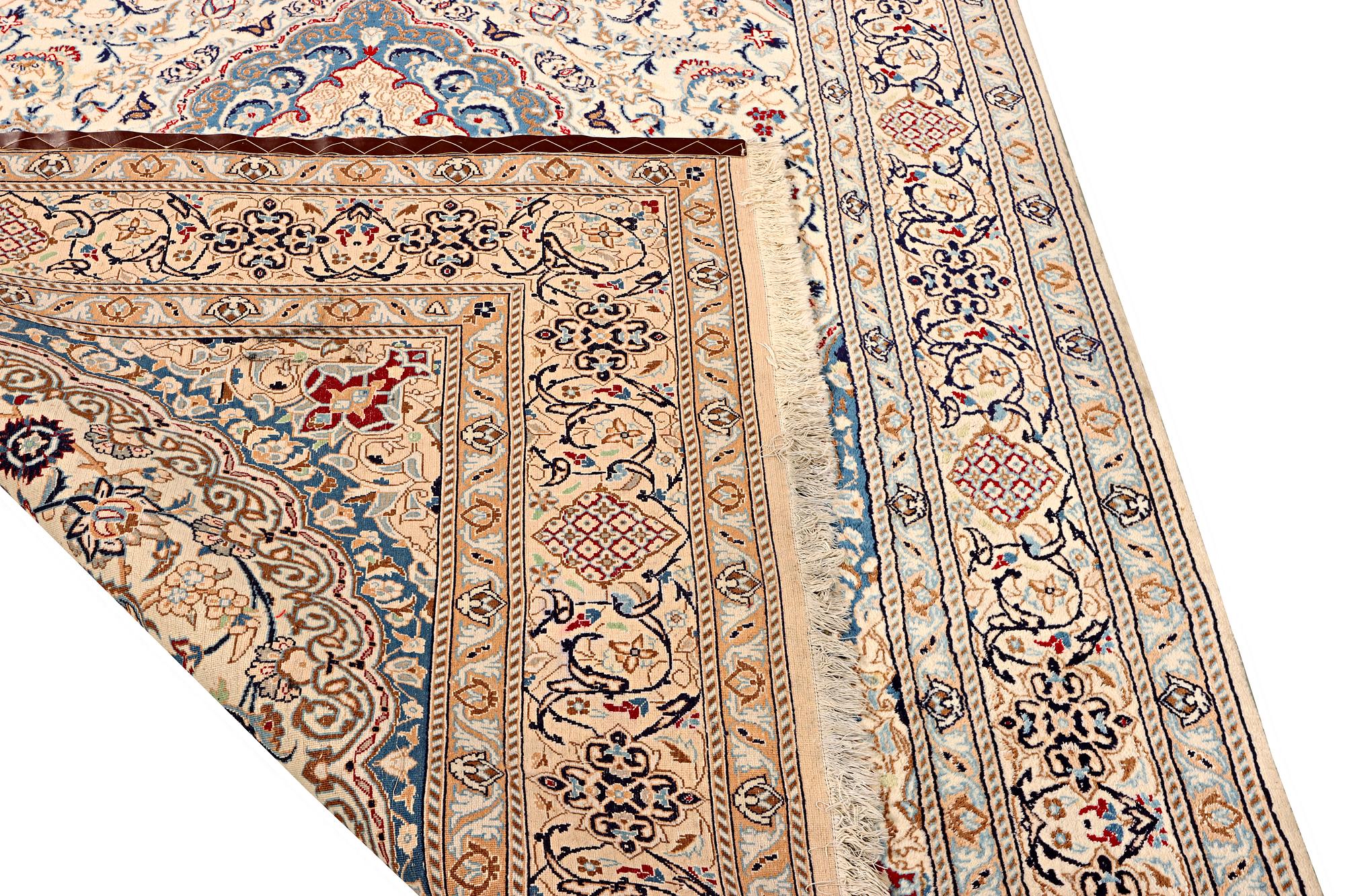 A Nain carpet, part silk, 9 laa, c. 300 x 195 cm.