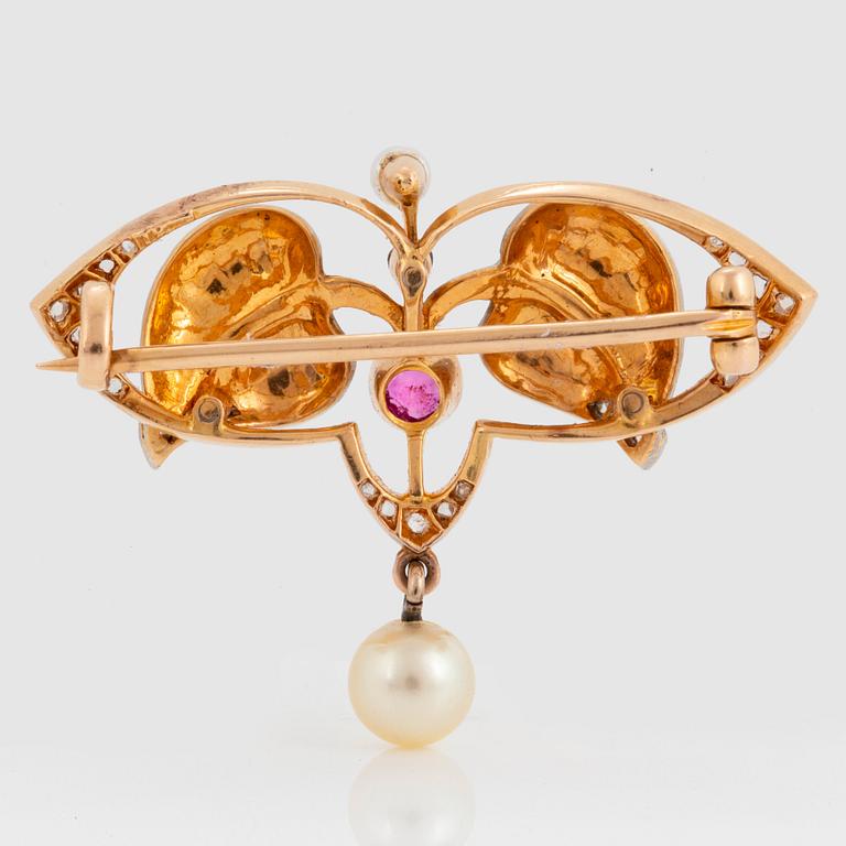 An 18K gold and platinum brooch set with pearls, rose-cut diamonds and a ruby.