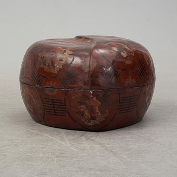 A massive Japanese wooden and lacquered box with cover, in the shape of a peach, early 20th century.