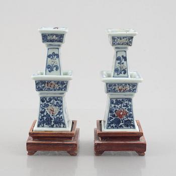 A pair of Chinese porcelain altar sticks, late Qing dynasty.