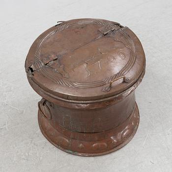 A copper water container, dated 1706.