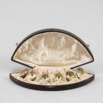 A set of six German parcel-gilt silver 800 salt cellars in fitted case.