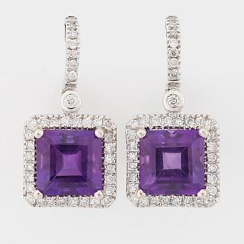 A pair of faceted amethyst and brilliant cut diamond earrings.