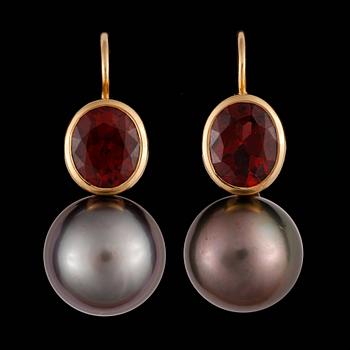 134. A pair of Tahiti pearl, 13 mm, and garnet earrings.