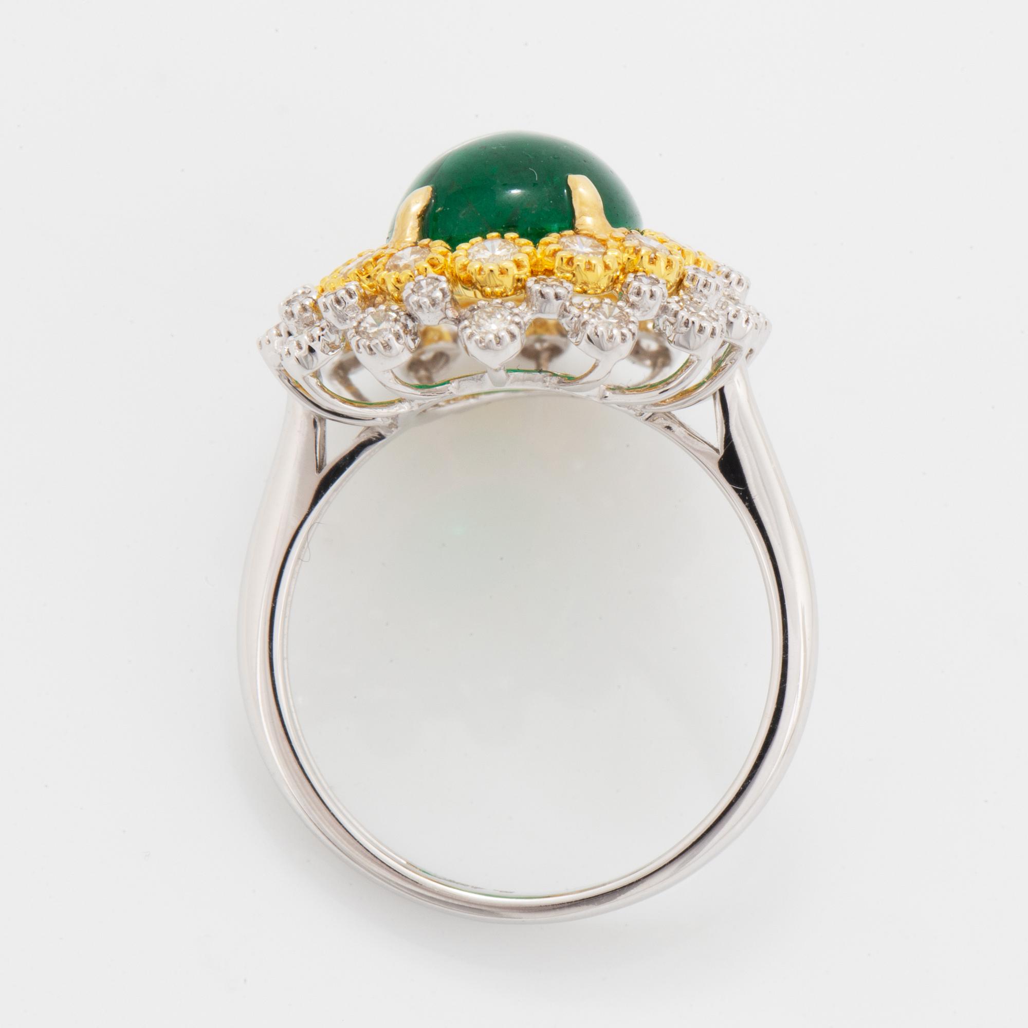 Cabochon-cut emerald and brilliant-cut diamond ring.