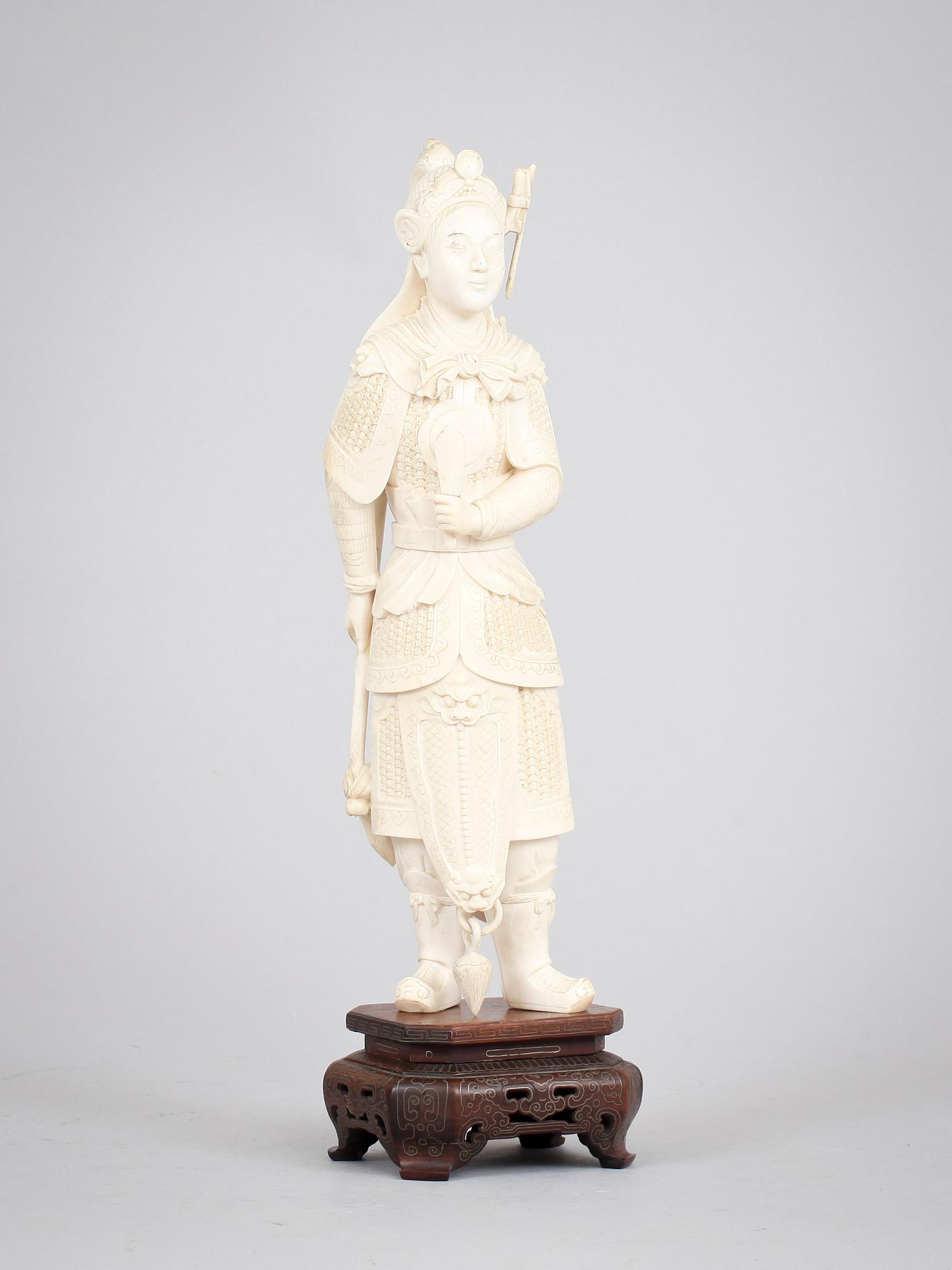 A carved ivory figure of a soldier in arms, late Qing dynasty, circa 1900.