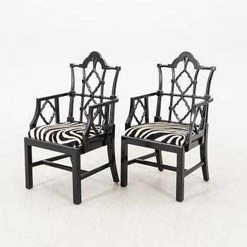 A pair of modern Eichholtz armchairs.