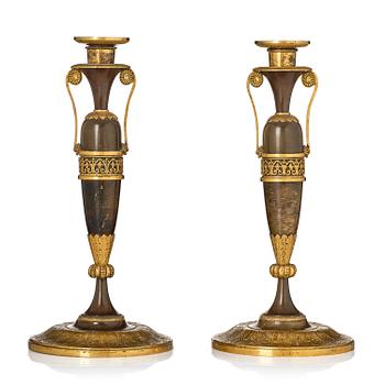 153. A pair of French Empire ormolu and patinated candlesticks in the manner of Claude Galle, Paris, early 19th century.