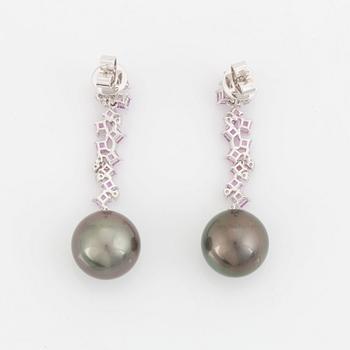 A pair of 18K white gold earrings set with Tahitian cultured pearls and round brilliant-cut diamonds.