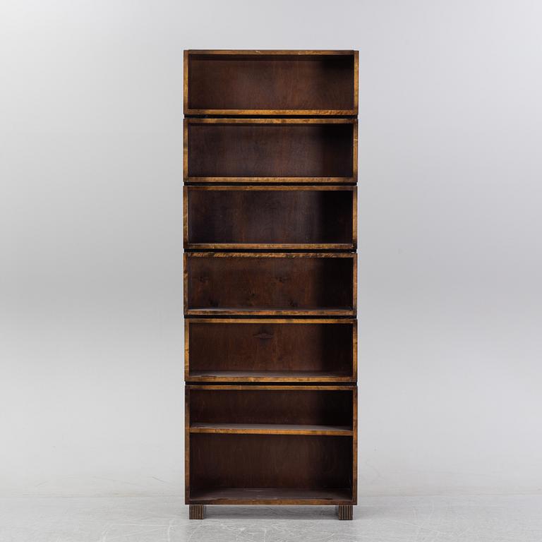 A stained birch shelving system, first half of the 20th Century.