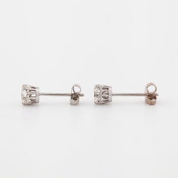 A pair of brilliant cut diamond earrings.