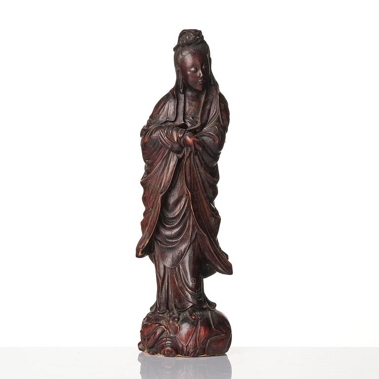 A wooden sculpture of Guanyin with metal inlay, Qing dynasty.