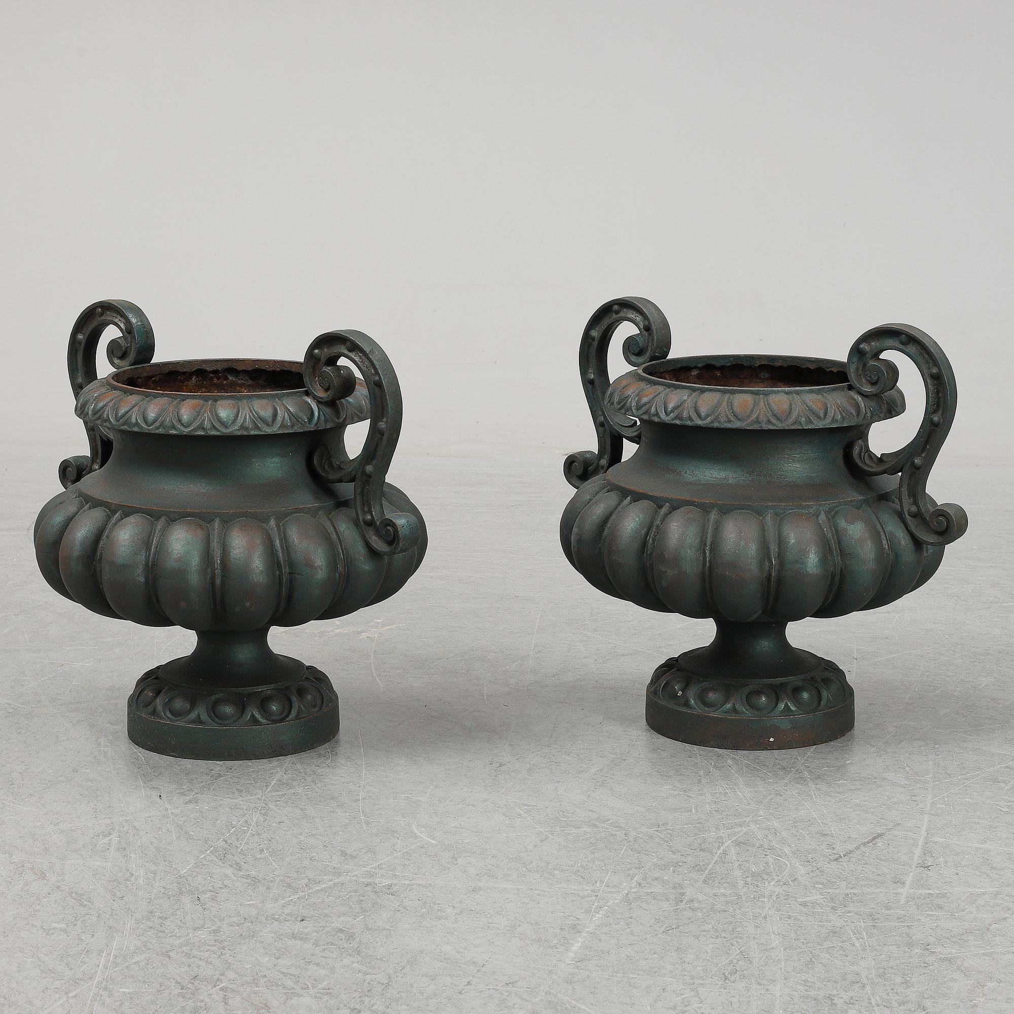 A 20th Century pair of cast iron flower pots.