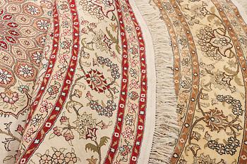 An oriental silk rug, diameter c. 216 cm.