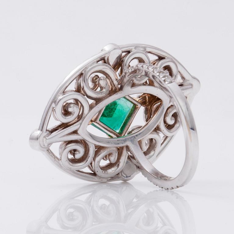 An octagonal/step-cut emerald, 1.65 cts, and diamond 1.25 cts (pavé-set) ring.