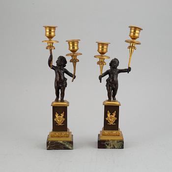 A pair of bronze empire style candleabra, 20th century.