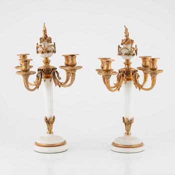 A pair of Louis XVI-style marble and gilt-bronze four-light candelabra, late 19th century.