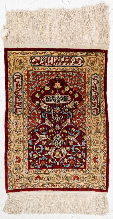 A silk and metal Hereke rug, West Anatolia, c. 58 x 39 cm.