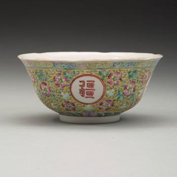 A famille rose yellow ground bowl. Late Qing dynasty, circa 1900, with Guangxu's six character mark.