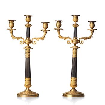 A pair of French Empire three-light candelabra, early 19th century.