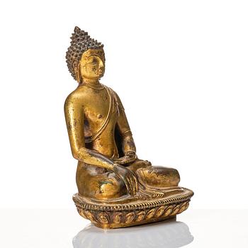 A gilt copper alloy figure of buddha, Nepal, 18th Century.