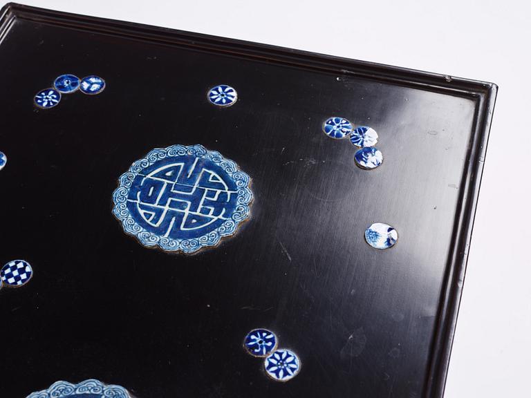 A Chinese black lacquered table with porcelain placques, presumably first half of the 20th century.