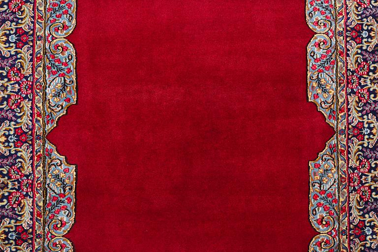 An old Kerman carpet, signed, c. 290 x 208 cm.