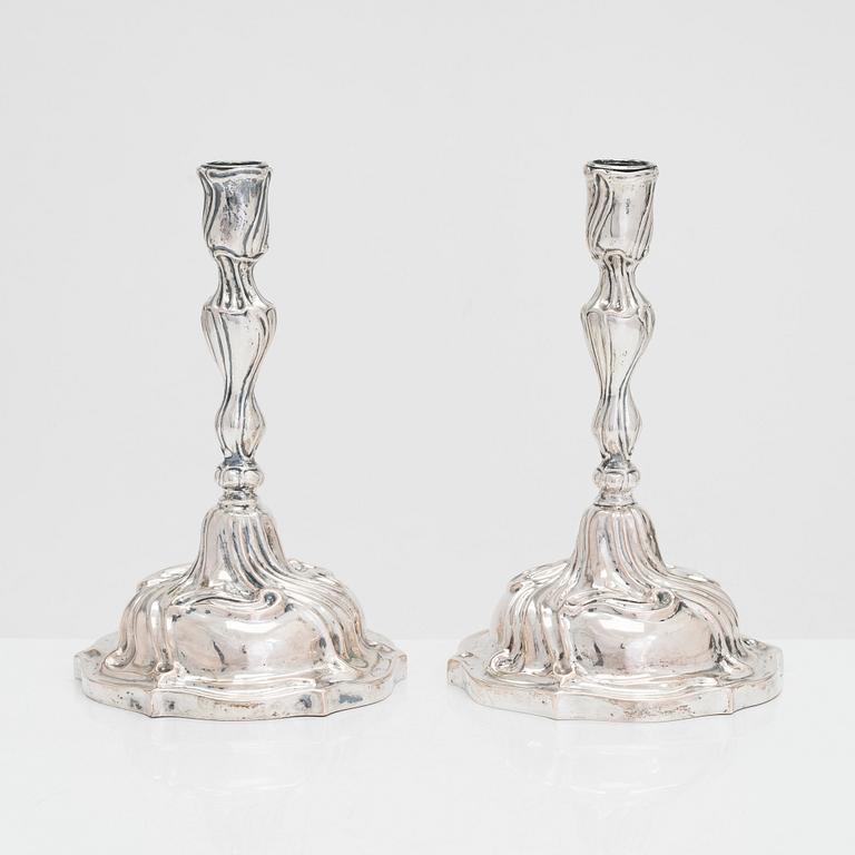 A pair of 18th-century Rococo silver candlesticks from Germany with later candelabra arms. Unindtified maker's mark.