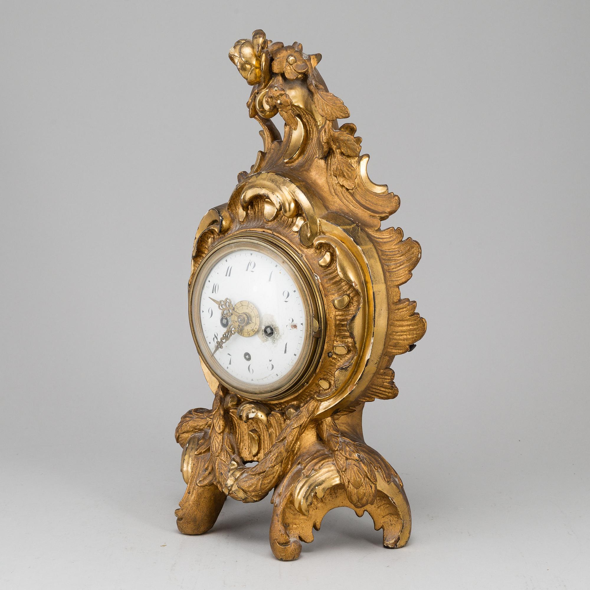 A swedish rococo gilt wood mantle clock.