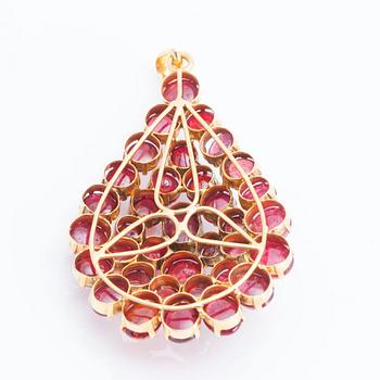 A cabochon-cut ruby pendant.
